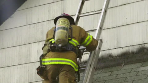 Fireman comes down a ladder Stock Footage 60795253