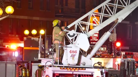 Fireman controlling ladder at night Stock Footage 139663857