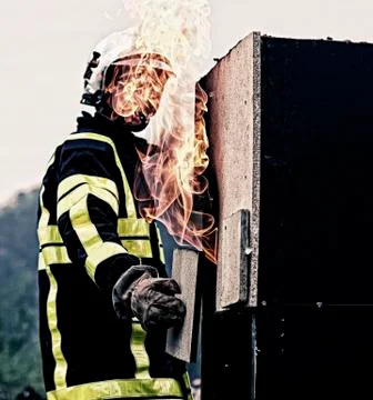 Fireman covering a flame Stock Photos