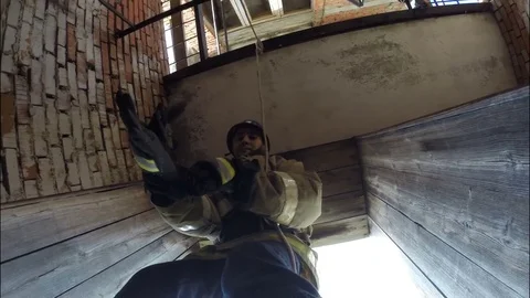 The fireman descends the rescue rope from the tower. Training . Video stock 76361059