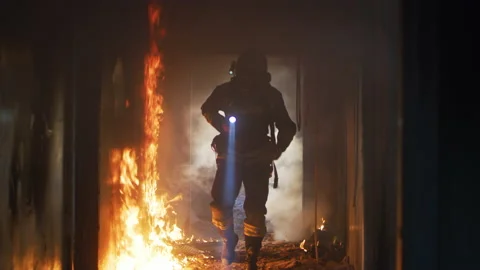 Fireman examining burning corridor during rescue mission Stock Footage 159071893