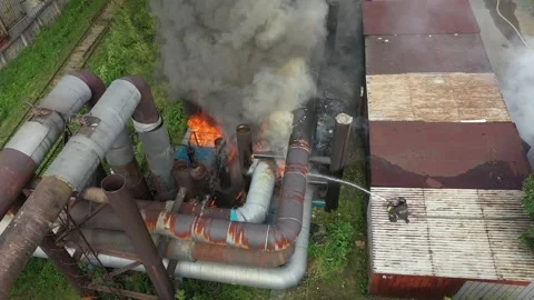 Fireman extinguishes the fire on heating main. Stock Footage 206004524