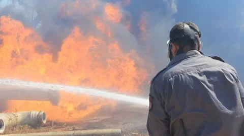 Fireman extinguishing burning grass forest  Emergency flames smoke fire tree Stock Footage 12049899