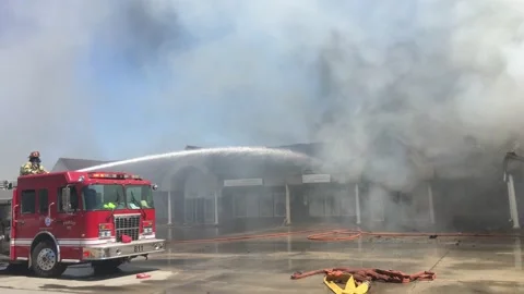 Fireman Fighting Fire with Hose Stock Footage 171437348
