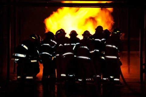 Fireman fighting fire Stock Photos
