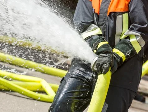 Fireman with a firehose Stock Photos