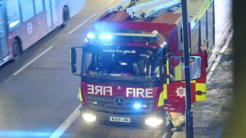 A fireman gets into a fire engine in London at night, England Stock Footage 165258034