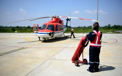 Fireman is guarding for helicopter. Stock Photos
