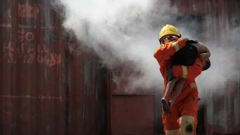 Fireman helping boy from the house fire burning slow motion Stock Footage 105603530