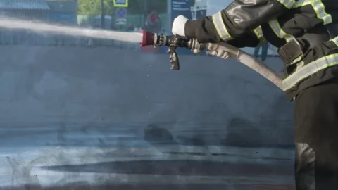 Fireman Hoses Down a Fire Scene HD Pro Stock Footage 257474260