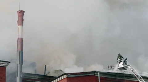 Fireman up a ladder fighting a fire Stock Footage 34553606