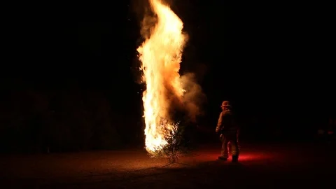 Fireman lighting a Christmas tree on fire Stock Footage 122306347