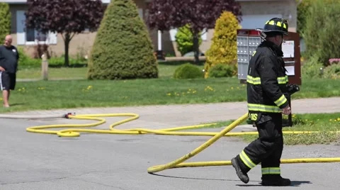 Fireman moving firehose Stock Footage 64222857