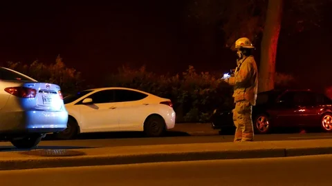 Fireman noting immatriculation after hit and run Stock Footage 116100207