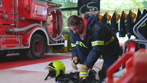 Fireman or fire fighter check the quality and function of tools for work Stock Footage 156989817