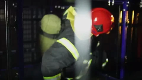 Fireman in protective suits crawls in cage of training facilities during light Stock Footage 276368568