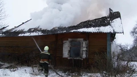 Fireman puts out burning house.. Belarus/Oshmyany/18 December 2018 Stock Footage 100530428