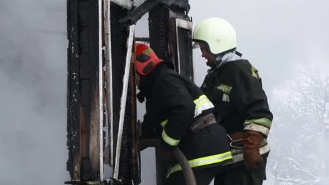 Fireman puts out burning house.. Belarus/Oshmyany/18 December 2018 Stock Footage 100530482