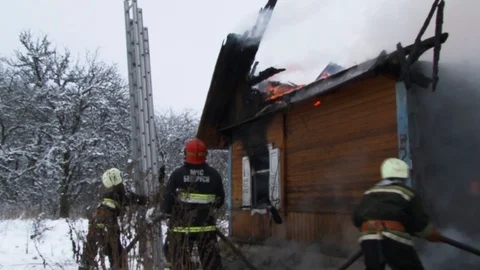 Fireman puts out burning house.. Belarus/Oshmyany/18 December 2018 Stock Footage 100530537
