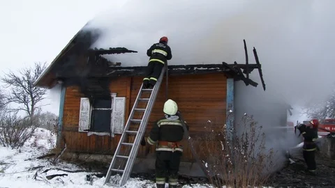 Fireman puts out burning house.. Belarus/Oshmyany/18 December 2018 Stock Footage 100530564