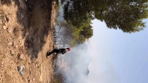 Fireman puts out fire in park Stock Footage 113827624