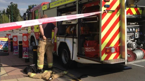 Fireman putting on overalls - on site Stock Footage 37115591