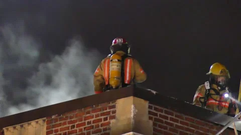 Fireman on the roof during fire Stock Footage 139663873