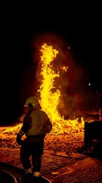 Fireman saving a fire with the hose on the ground Stock Photos