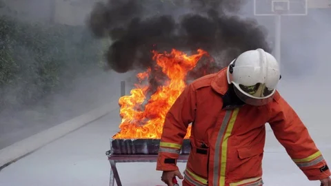 Fireman sets up training exercise on fighting fire cinemagraph plotagraph Stock Footage 97739611