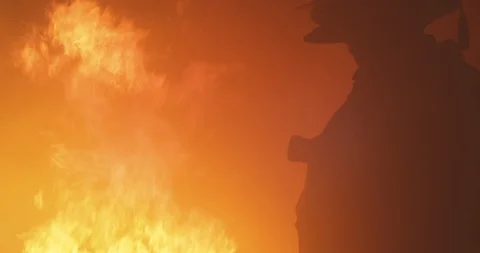 Fireman standing in front of fire Stock Footage 91153417
