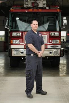 Fireman standing in front of fire station Stock Photos