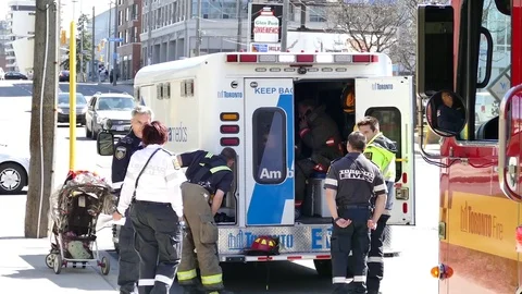 Fireman talking on cellphone in the back of ambulance Stock Footage 77893905