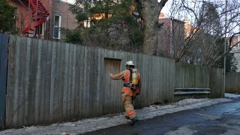 Fireman trying to access backyard Stock Footage 138497437