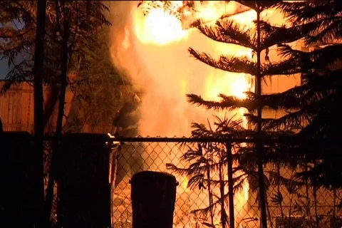 Fireman Uses Hook on Burning Building 動画素材 857524