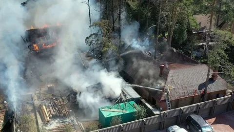 Fireman using high pressure hose on a structure fire. View from top close-up. Stock Footage 113112250