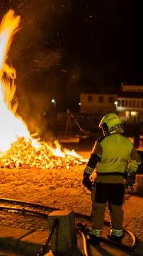Fireman watching a bonfire Stock Photos