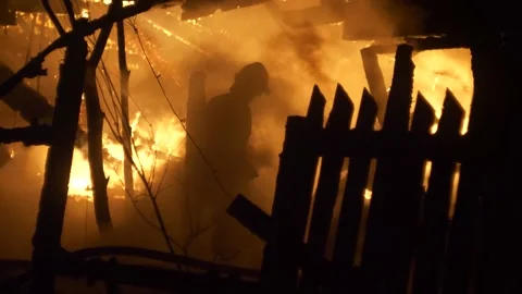 Fireman at work. Burning house. Video stock 221386630