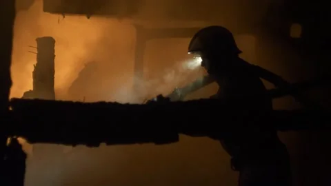 Fireman at work. Burning house. Video stock 221386646