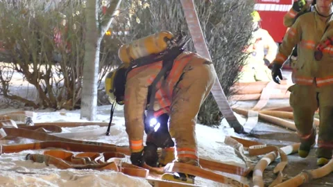 Fireman working hard in the winter Stock Footage 139663846