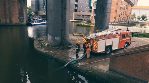 Firemans and fire truck. Training near  Bridgewater canal in Manchester Stock Footage 121768632