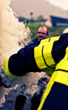 Fireman's arm in the smoke Stock Photos