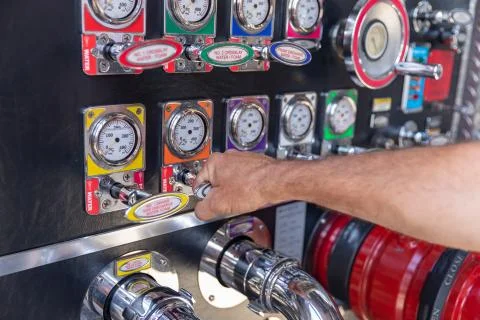 Fireman's hand  pulling valave on a fire engine Stock Photos