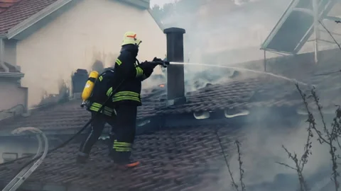 Firemen in action on burning ruins of building Stock Footage 237214529