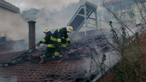 Firemen in action on burning ruins of building Stock Footage 237214832