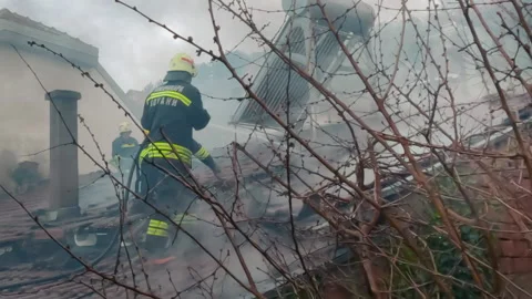 Firemen in action on burning ruins of building Stock Footage 237214881