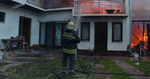 Firemen in action on burning ruins of building Stock Footage 237299239