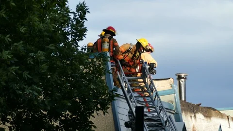 Firemen a afttermath of structure fire Stock Footage 116712807