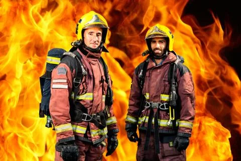 Firemen against burning background. Foto stock