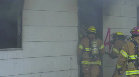 Firemen are about to enter burning house Stock Footage 60957283