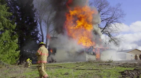 Firemen attack flames from the front Stock Footage 61170591